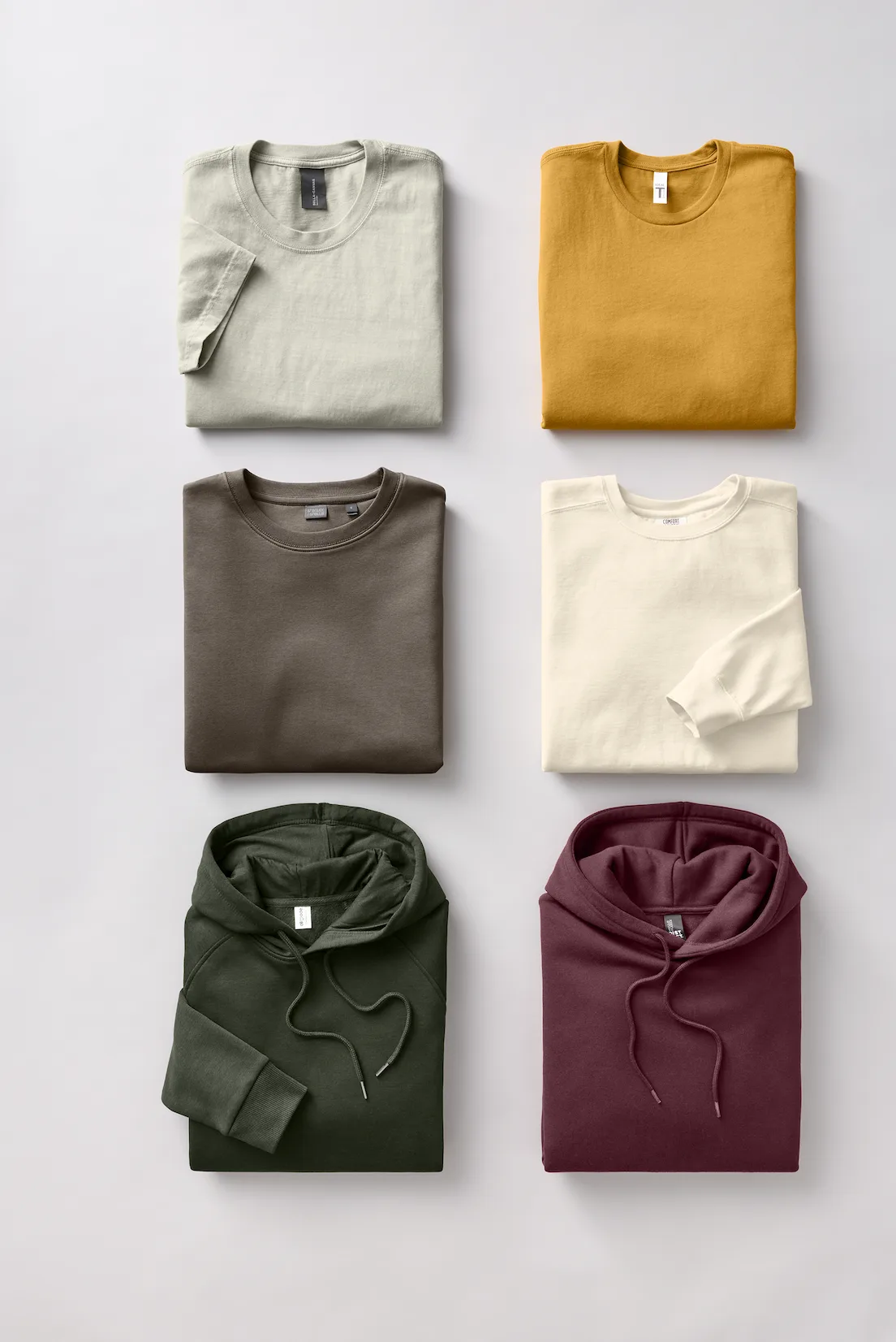 Folded stacks of premium branded apparel in muted tones